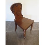 A late Victorian mahogany hall chair in polished condition