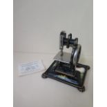 A Dorman lock stitch sewing machine, 22cm tall with stand, working and sympathetically repainted,