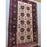 A Baluchi hand woven woollen rug with a cream field, 185cm x 120cm, in reasonably good condition,