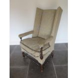 A walnut wing back chair with spiral twist supports and stretchers, 129cm tall x 75cm x 72cm deep,