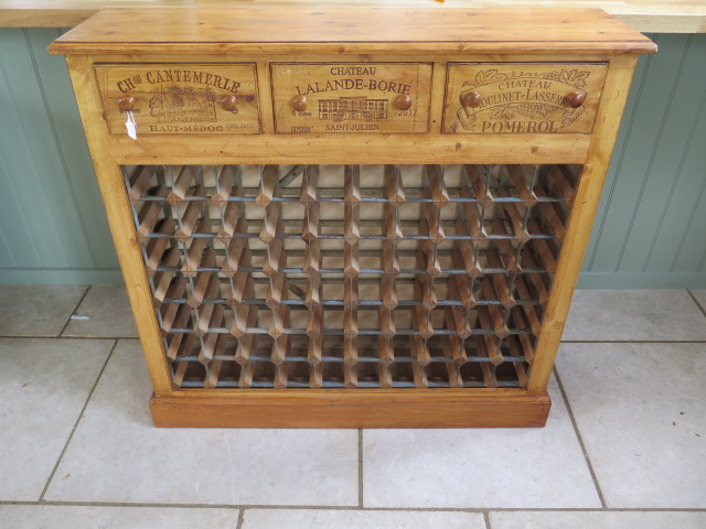 A new pine 70 bottle wine rack with three wine box fronted drawers made by a local craftsman to a