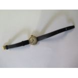 A 9ct yellow gold manual wind wristwatch on leather strap, 2cm wide, not working, total weight