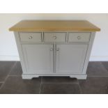 An ex-Bramblecrest grey painted two door cupboard with three frieze slow close drawers and oak