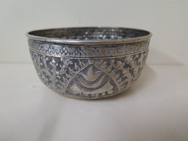 An Eastern embossed white metal bowl, 5.5cm tall x 11.5cm diameter, generally good condition, approx