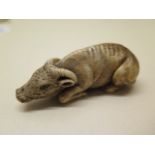 A well carved bone water buffalo Netsuke, 6.5cm long, in good condition