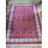 A red ground full pile rug allover floral pattern with gold border, 240cm x 160cm, in good condition