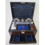 A Victorian walnut travel box with a fitted interior containing nine bottles and tidies with