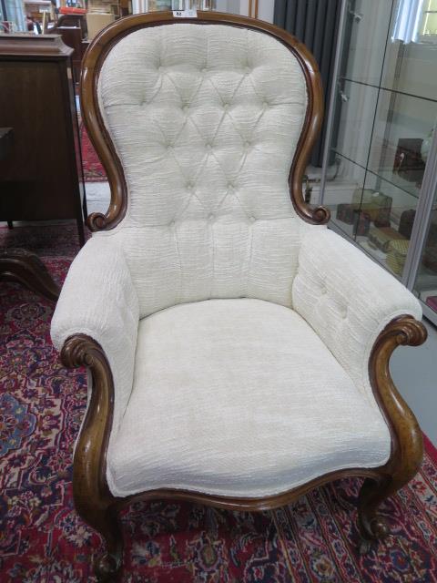 A Victorian mahogany button back upholstered armchair, recently re-upholstered and in good