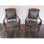 A pair of 19th French mahogany fauteuils scroll arm open armchairs with reupholstered leather