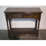 A 19th century oak side table with two drawers and an undertier, 84cm tall x 97cm x 41cm, with