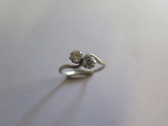 A white metal two stone diamond ring each diamond approx 0.40ct, size Q, approx 3.2 grams, ring