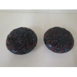 A pair of early 20th century Chinese red and black lacquer boxes and covers decorated top and base