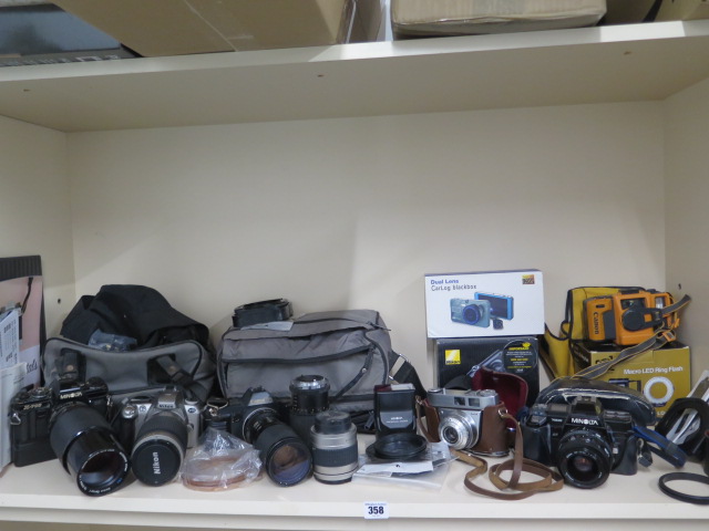 A collection of four SLR cameras with assorted lenses: Minolta X-700, Nikon F55, Canon T70,