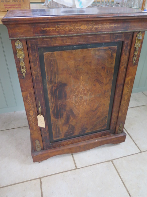 A 19th century walnut inlaid pier cabinet with a single door and ormulu mounts, 112cm tall x 83cm