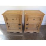 A pair of pine bedside cupboards with a frieze drawer 67 cm tall 53 by 38 cm