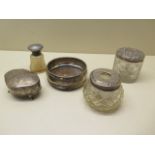 Three silver top bottles, a silver rim coaster and a silver trinket box, some denting to tidy and
