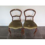 A pair of Victorian rosewood balloon back side chairs in sound condition, both with old professional