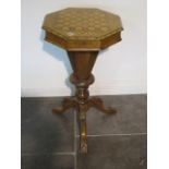 A Victorian walnut trumpet work box with an inlaid chessboard top and fitted interior on a tripod