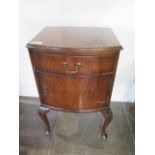 A walnut bow fronted bedside cupboard, 72cm tall x 45cm x 37cm