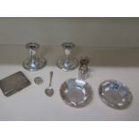 A pair of silver weighted dwarf candlesticks, 8cm tall, a silver top scent bottle with stopper, a