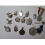 Nine silver fobs and badges approx 2.6 troy oz and seven commemorative tokens etc.