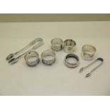 Six assorted silver napkin rings and two silver nips, approx 5.8 troy oz