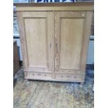 A Continental 19th century stripped pine double wardrobe with two base drawers, comes apart for ease