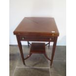 An Edwardian mahogany envelope fold over card table with a frieze drawer, 73cm tall x 54cm x 54cm