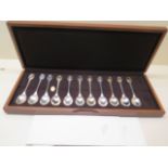 Eleven silver RSPB spoons in a presentation box, total approx 9 troy oz- one spoon missing one inset