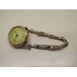 A 9ct yellow gold manual wind wristwatch with 9ct sprung strap, not running, small dents to case,