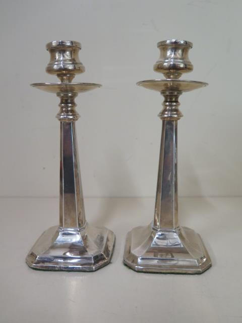 A pair of Art Nouveau silver weighted candlesticks, Chester 1913/14 JDWD, 18cm tall, some small