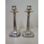 A pair of Art Nouveau silver weighted candlesticks, Chester 1913/14 JDWD, 18cm tall, some small