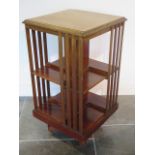 An Edwardian revolving mahogany bookcase, 88cm tall x 47cm x 47cm, all slats intact, some fading