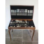 A part 12 setting Kings pattern plated cutlery set in mahogany canteen sidetable, missing 5 cake