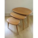 A nest of three Ercol ash blonde pebble tables, 41cm tall x 66cm x 44cm, some small usage marks