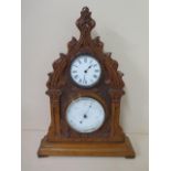 A gothic oak clock barometer with thermometer, 43cm tall, ticks but stops, hand off barometer
