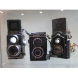 Three vintage TLR cameras; a Zeiss Ikon Ikoflex, a cased Lubitelz and a Rollop automatic, all have