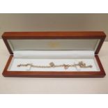 A Clogan 9ct gold charm bracelet 19cm long, approx 15.6 grams in good condition with box, marked 75