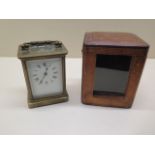 A brass carriage clock, 12cm tall, in running order, dial and glass good with original carry case