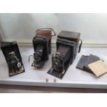 Three folding cameras; a Goerz Tenax plate camera, Kodak No:1 autographic JR in a leather case and a