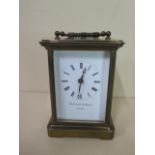 A brass carriage clock Matthew Norman of London, 12cm tall, working with key case and glass good