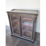 A Victorian ebonised two door glazed side cabinet with brass gallery, in need of some restoration,