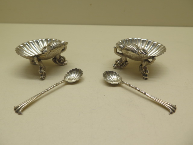 A pair of silver shell salts Birmingham 1887/88 H & T with a pair of near matching spoons, salts 5.