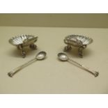 A pair of silver shell salts Birmingham 1887/88 H & T with a pair of near matching spoons, salts 5.