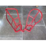 Two red painted metal saddle and bridle racks 50 and 54 cm long