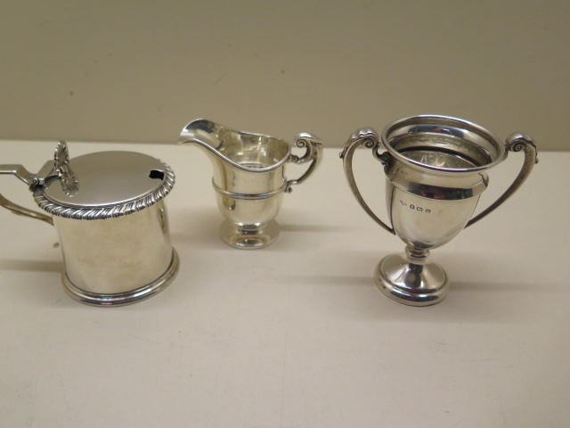 A Victorian silver mustard with a replacement glass liner, a Chester silver jug, and a silver cup