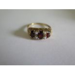 A hallmarked 9ct yellow gold garnet and opal ring, size O, approx 3.4 grams in good condition