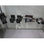 Five vintage film cameras to include an early EXA SLR, Art Deco design folding Kodak, Kodak Retina