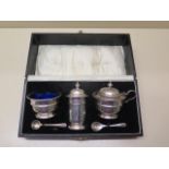 A silver three piece cruet set boxed, approx 4 troy oz, generally good