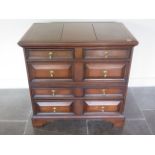 An antique oak chest with two short over three long moulded fronted drawers on bracket feet, comes